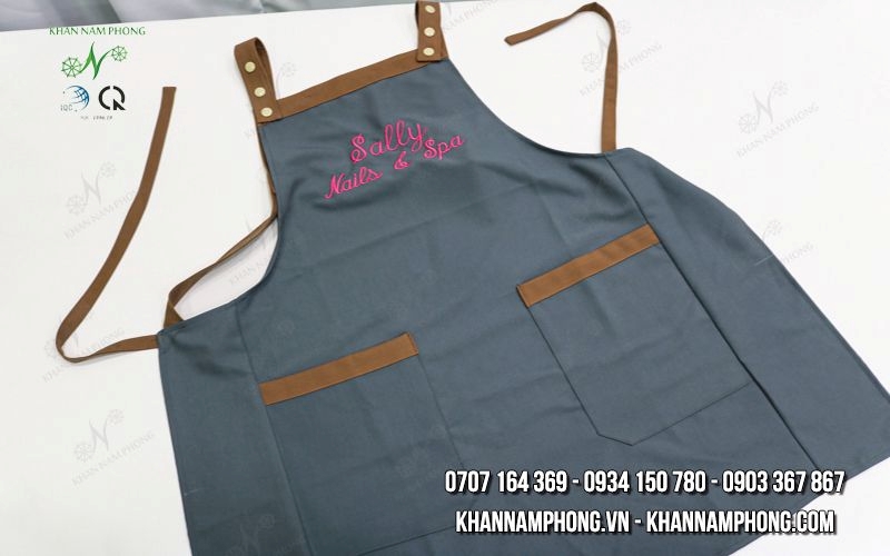 Tạp Dề Nails &Amp; Spa Màu Xanh Đen Phối Nâu Cotton Lạnh Cổ Vuông Freesize Thêu Logo Sally Tạp Dề Nails & Spa Màu Xanh Đen Phối Nâu Cotton Lạnh Cổ Vuông Freesize Thêu Logo Sally