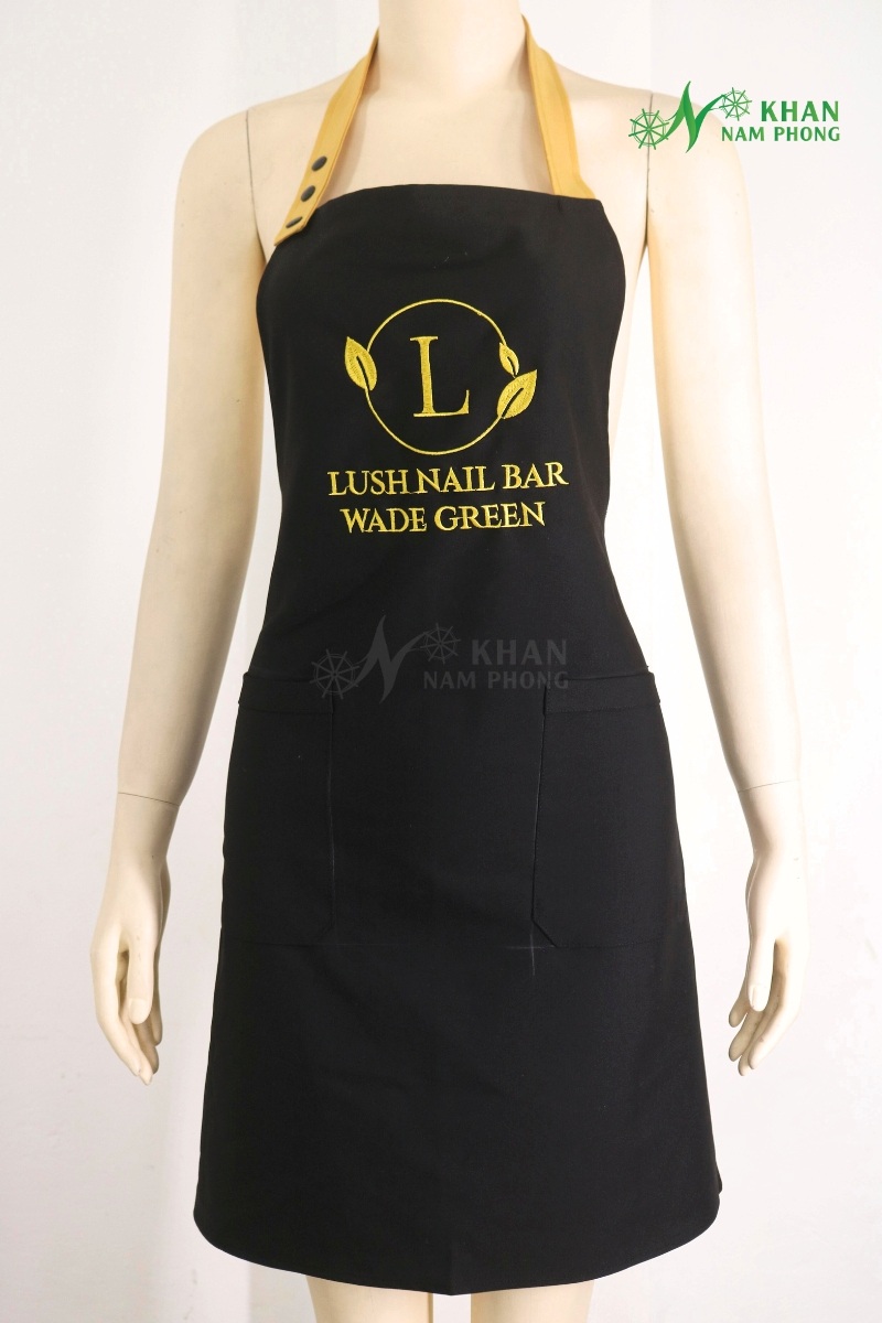 Tạp Dề Nail Màu Đen Phối Vàng Cotton Lạnh Thêu Logo Lush Nail Bar Wade Green Freesize Tạp dề nail màu đen phối vàng cotton lạnh thêu logo Lush Nail Bar Wade Green freesize